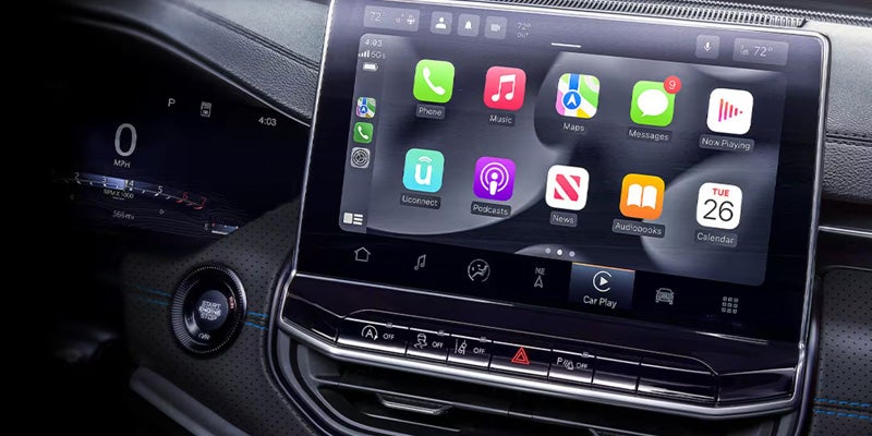 Dashboard featuring a large touchscreen with Apple CarPlay apps, digital speedometer displaying 0 mph, and start button.