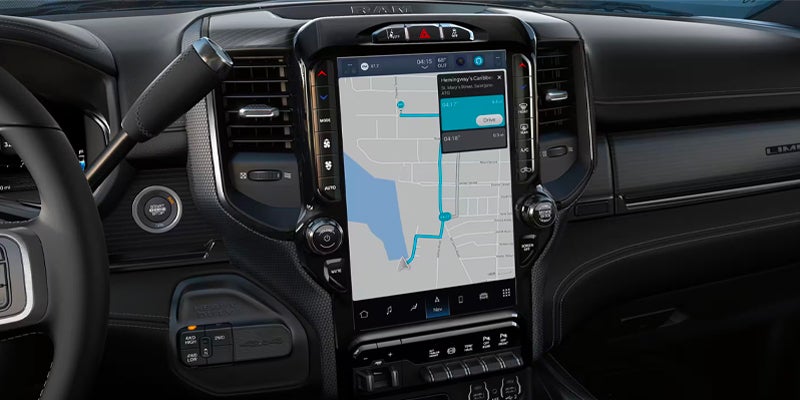 Interior of a modern vehicle with a large central touchscreen displaying a GPS navigation map.