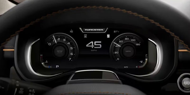 A car's digital dashboard showing 45 MPH, rpm, temperature, fuel, and the "TUNGSTEN" branding.